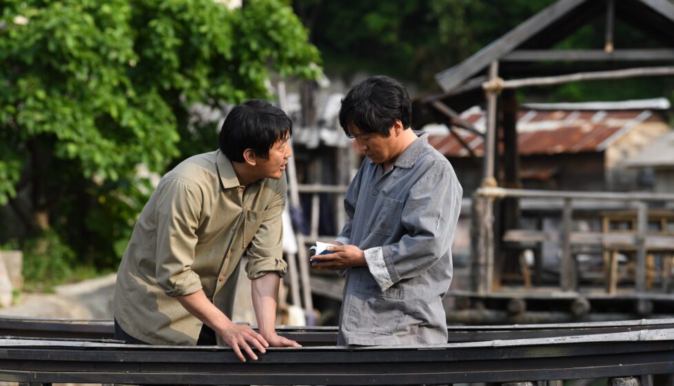 One man with Bible standing with another man