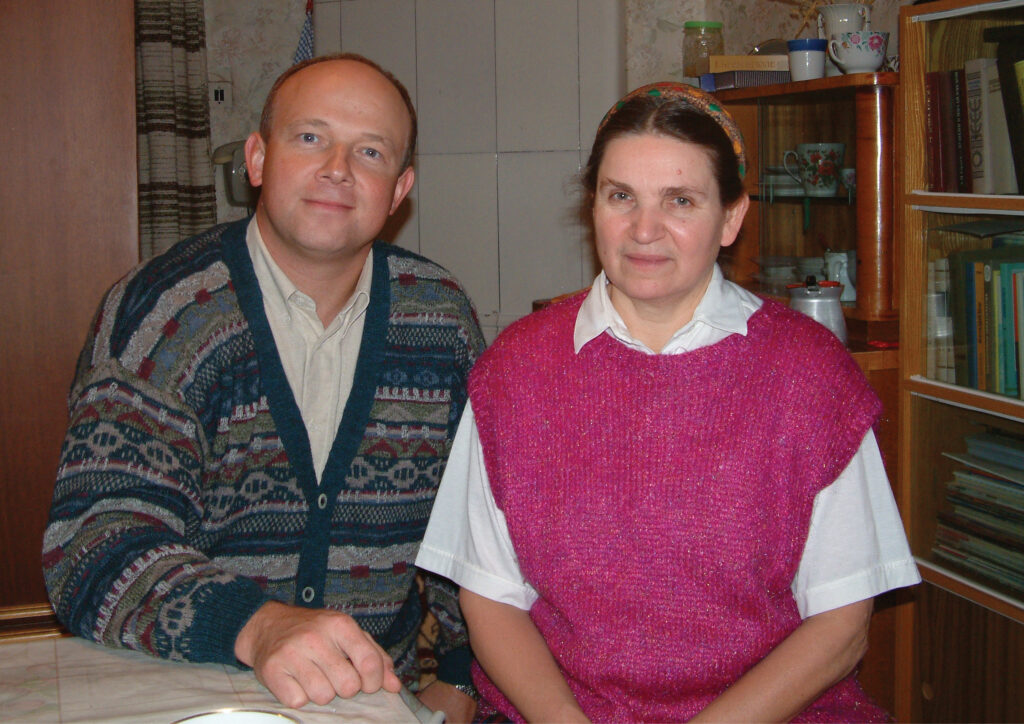 man and woman sitting next to one another