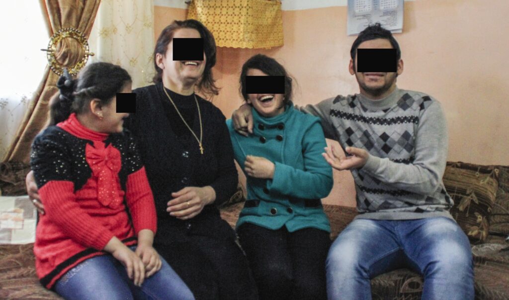 Rebekah and her family sitting together and laughing