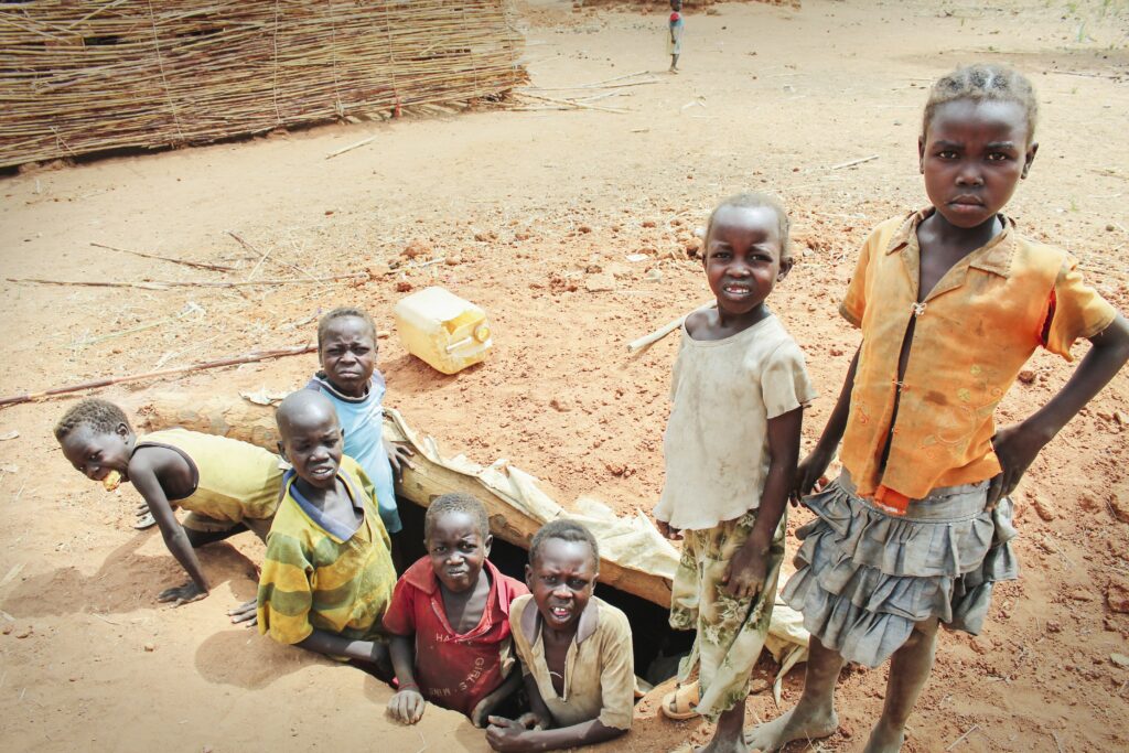 seven kids standing outside 