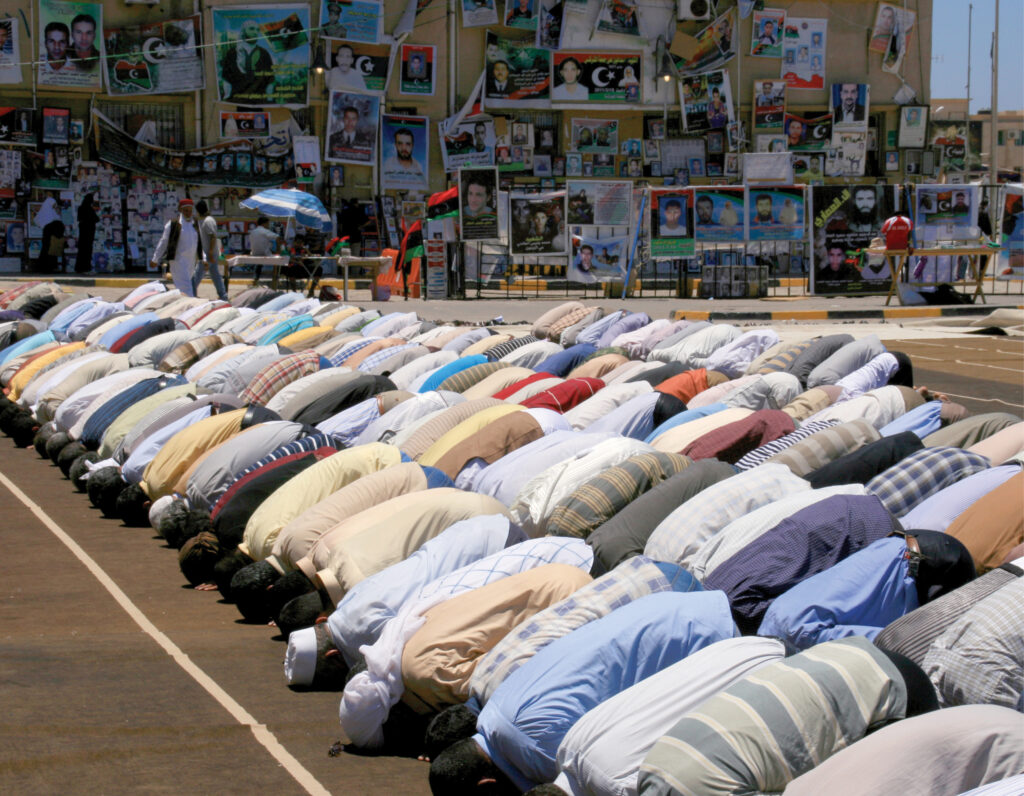 group of hindu people bowing in prayer
