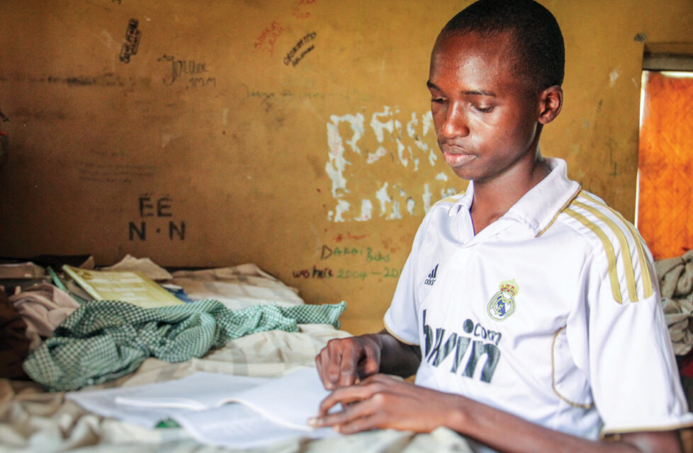A boy sits at his desk and reads the bible